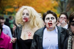 Photo: A couple dressed as zombies - Danny Zucco and Sandy Olsson from the movie Grease walking in the annual Toronto Zombie Walk.